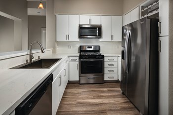 Kitchen with stainless steel appliances at The Madison at Town Center Apartments in Santa Clarita CA